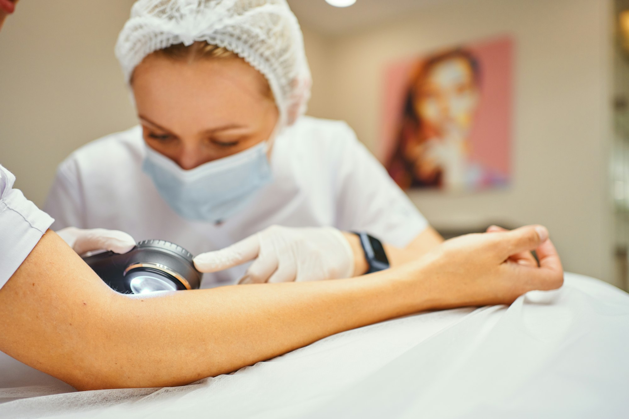 A dermatologist examines the skin.